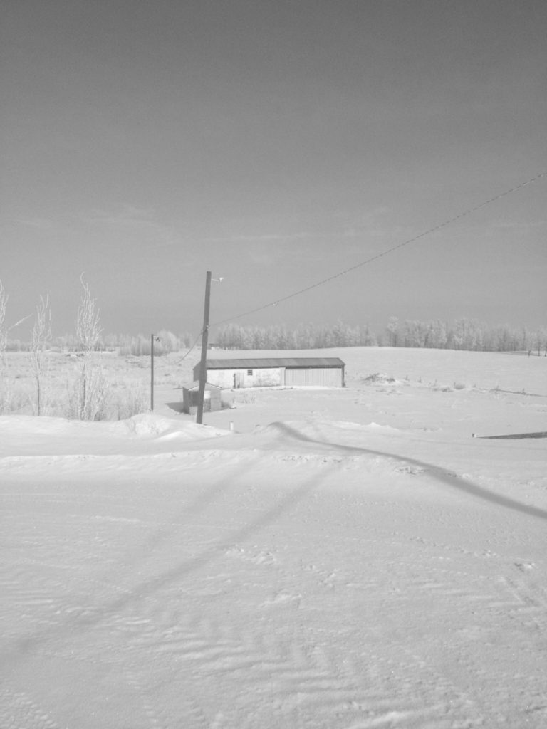 barn in snow covered field