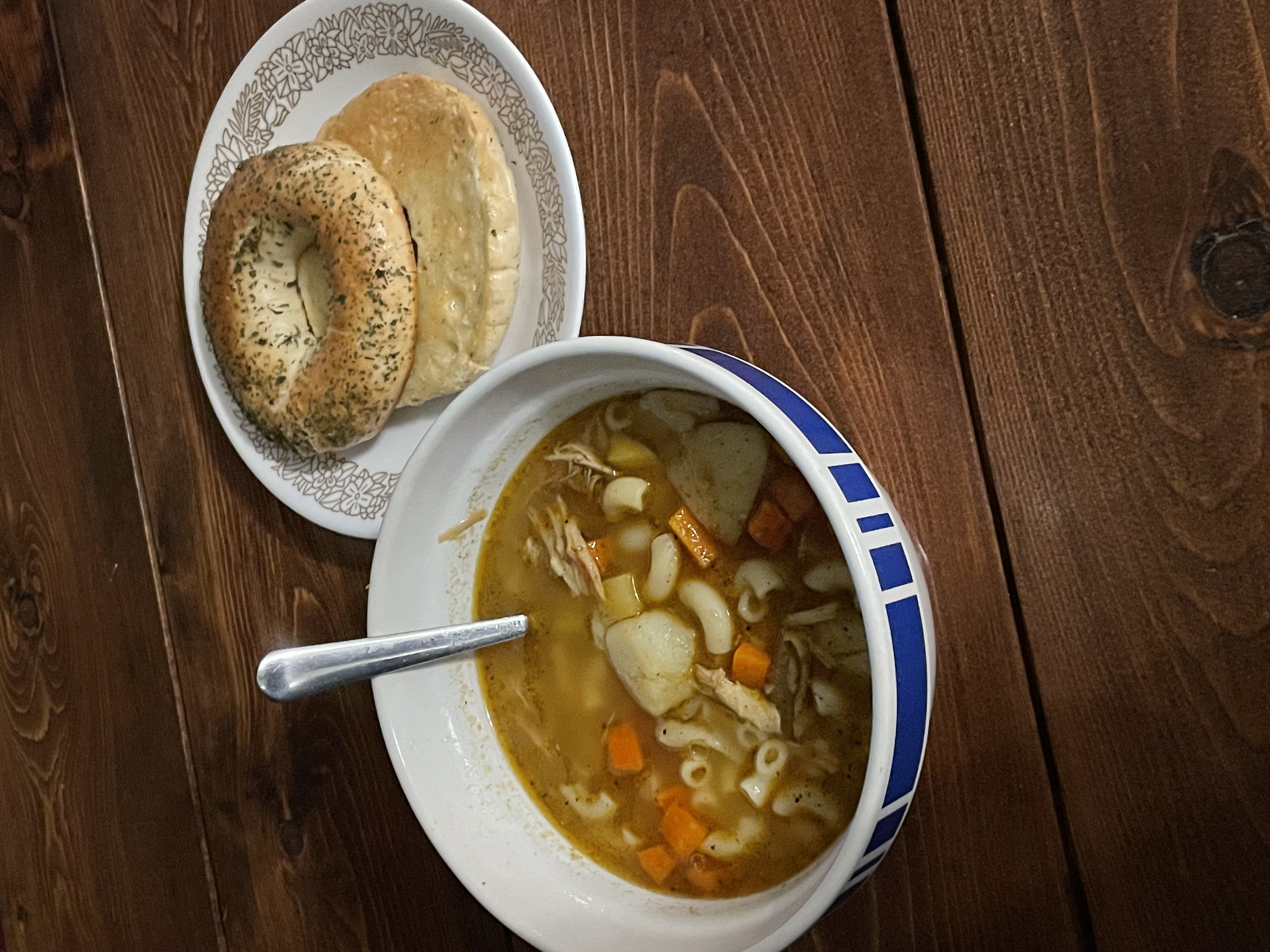 bowl of turkey soup with a bagel